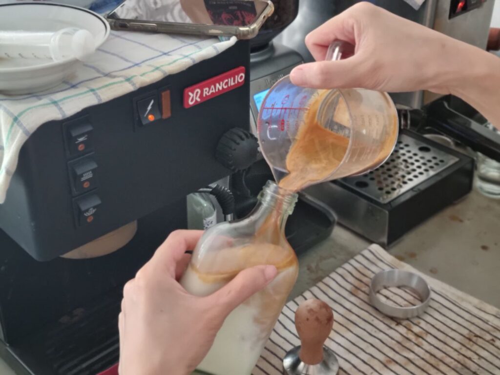 Pouring espresso into a bottle